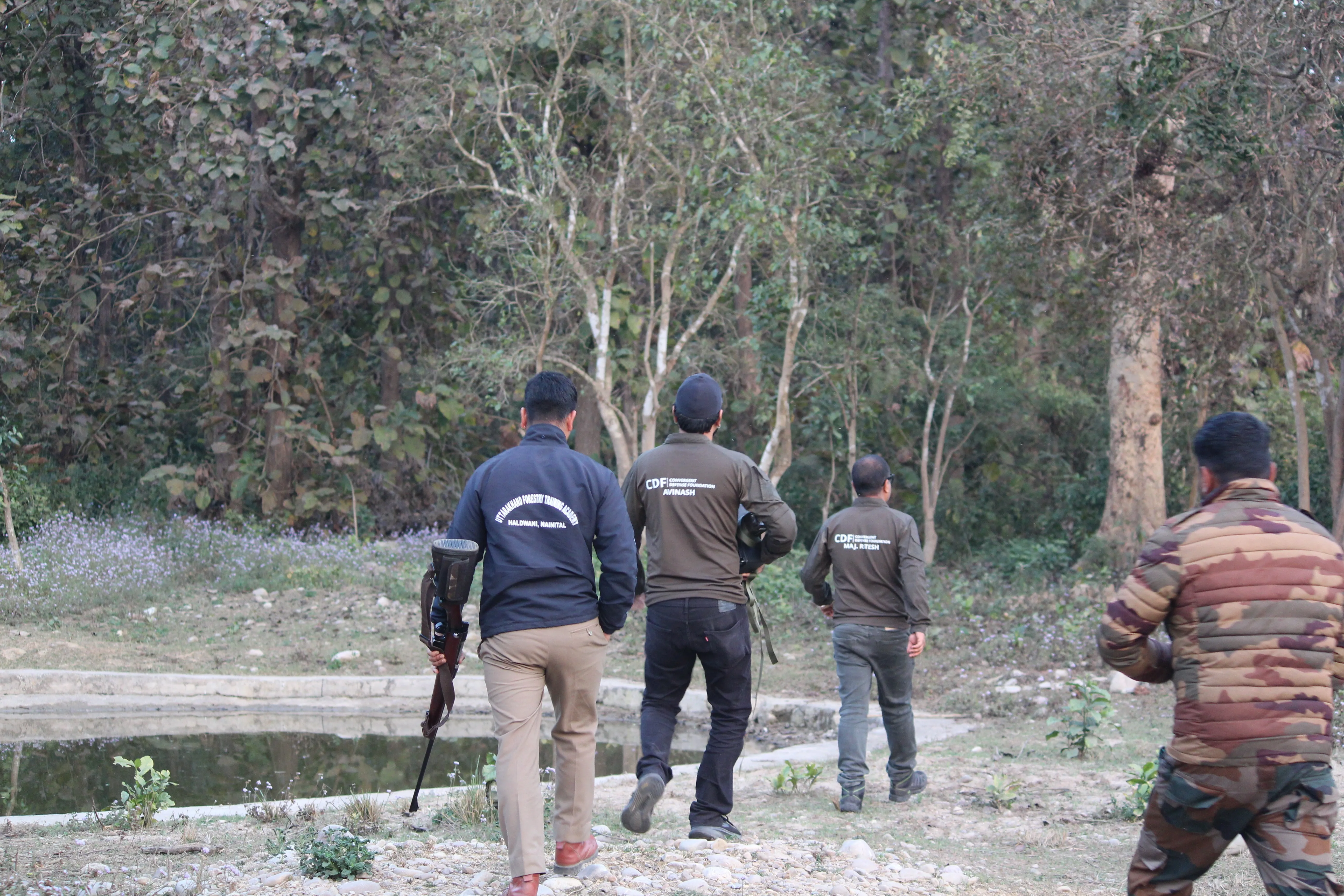 The CDF team walking into the trial forest with forest department staff