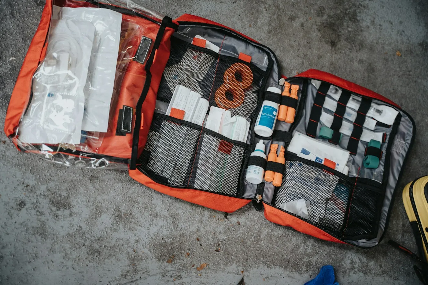 An open first-aid kit laid out on the ground