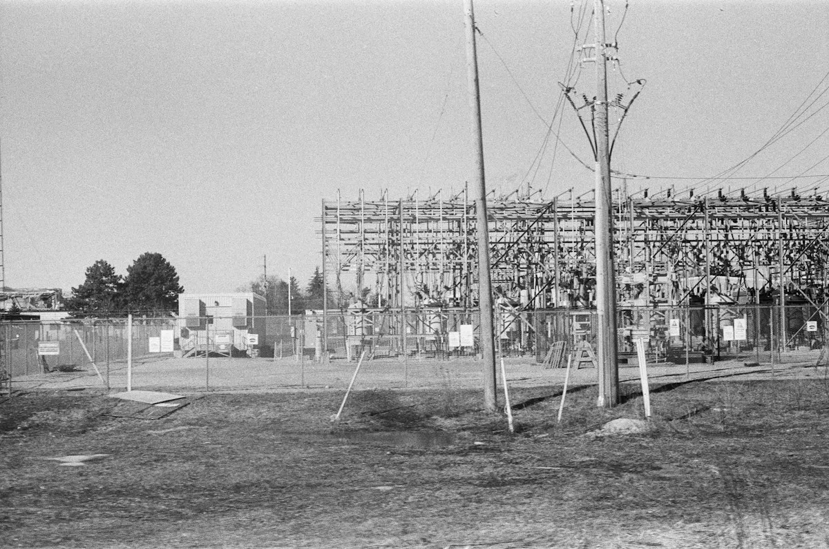 An electrical substation with transformers and power lines